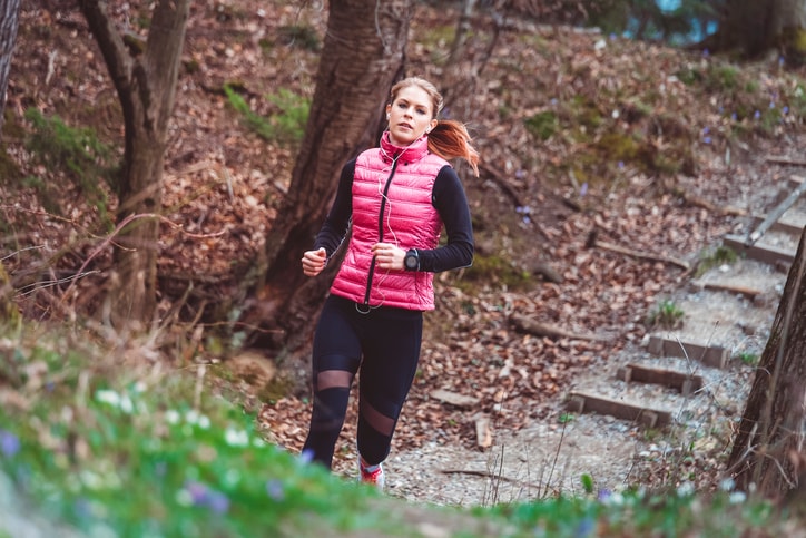 woman running through woods